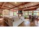 A comfortable living room has a fireplace, hardwood floors, and windows overlooking the backyard at 3737 26Th St, Boulder, CO 80304