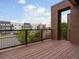 Balcony view showcasing a modern building complex, blue skies, and tree lined streets at 8336 E 35Th Ave, Denver, CO 80238