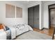 Bright bedroom featuring a twin bed, sliding closet doors, and modern wall art at 8336 E 35Th Ave, Denver, CO 80238