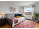 Cozy bedroom featuring a gray daybed with colorful pillows and a patterned rug at 8336 E 35Th Ave, Denver, CO 80238
