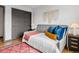Comfortable bedroom with a gray daybed, a sliding door closet, and a decorative wall hanging at 8336 E 35Th Ave, Denver, CO 80238