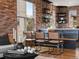 Cozy dining area with exposed brick, stylish chairs and modern accents, open to living area at 8336 E 35Th Ave, Denver, CO 80238