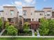 Attractive townhomes with private balconies, well-maintained lawns, and mature trees at 8336 E 35Th Ave, Denver, CO 80238