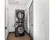 Modern laundry room featuring a stacked washer and dryer unit for space-saving convenience at 8336 E 35Th Ave, Denver, CO 80238