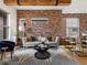 Comfortable living room with exposed brick wall, neutral sofa and decorative accents at 8336 E 35Th Ave, Denver, CO 80238
