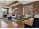 Stylish living room with exposed brick, contemporary furniture and ample natural light at 8336 E 35Th Ave, Denver, CO 80238