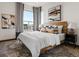 Spacious main bedroom features modern decor, large windows, and stylish furniture at 8336 E 35Th Ave, Denver, CO 80238