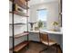 Bright home office featuring built in desk, floating shelves, and natural light at 8336 E 35Th Ave, Denver, CO 80238