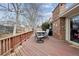 Wooden back deck with outdoor dining set and red-painted railing at 8205 Dudley Way, Arvada, CO 80005