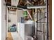 Unfinished basement laundry area with washer, dryer, and exposed ceiling at 8205 Dudley Way, Arvada, CO 80005