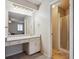 Bathroom featuring vanity with sink and a shower with glass doors at 8205 Dudley Way, Arvada, CO 80005
