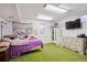 Bedroom with green carpet and unicorn decor at 8205 Dudley Way, Arvada, CO 80005