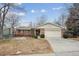 Charming single-story home featuring a brick facade, two-car garage, and well-maintained front yard at 8205 Dudley Way, Arvada, CO 80005