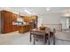 Bright kitchen area with skylight, wood cabinets, granite countertop, and adjacent dining space at 8205 Dudley Way, Arvada, CO 80005