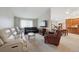 Comfortable living room with carpet, natural light and modern television set above furniture at 8205 Dudley Way, Arvada, CO 80005