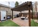 Charming backyard patio with a pergola, string lights, a gas grill, and cozy seating at 3220 W 24Th Ave, Denver, CO 80211