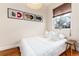 Cozy bedroom with record art, a natural light window, and minimalist decor at 3220 W 24Th Ave, Denver, CO 80211