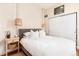 Cozy bedroom with white linens, wood floors, closet and natural light at 3220 W 24Th Ave, Denver, CO 80211