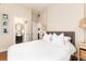 Light-filled bedroom with ensuite bathroom, hardwood floors, closet, and decorative pendant lighting at 3220 W 24Th Ave, Denver, CO 80211