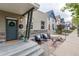 Inviting front porch with seating, featuring stone accents and pleasant neighborhood views at 3220 W 24Th Ave, Denver, CO 80211