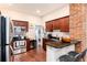 Well-lit kitchen featuring granite countertops, cherry cabinets, stainless steel appliances, and breakfast bar seating at 3220 W 24Th Ave, Denver, CO 80211