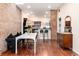 Stylish dining area featuring a brick wall and an open layout at 3220 W 24Th Ave, Denver, CO 80211