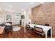 Spacious living area with hardwood floors, brick wall, and open concept design at 3220 W 24Th Ave, Denver, CO 80211