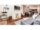 Bright living room featuring a fireplace, hardwood floors, and open concept design at 3220 W 24Th Ave, Denver, CO 80211