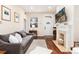 Cozy living room with a fireplace, hardwood floors, and natural light at 3220 W 24Th Ave, Denver, CO 80211