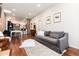 Inviting living area with hardwood floors, brick accent wall, and comfortable seating at 3220 W 24Th Ave, Denver, CO 80211