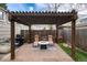 Outdoor patio featuring fire pit, string lights, seating, grill and privacy fence at 3220 W 24Th Ave, Denver, CO 80211