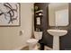 Modern powder room features a pedestal sink, stylish accents, and neutral tones at 9279 Merino Ct # D, Littleton, CO 80125