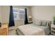 Bedroom with a window view, neutral paint, and a comfortable bed at 9279 Merino Ct # D, Littleton, CO 80125