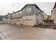 Exterior view of townhouse-style homes with private garages and well-maintained landscaping at 9279 Merino Ct # D, Littleton, CO 80125