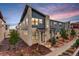 Beautiful two-story townhome featuring stone accents, landscaped front yard, and craftsman-style details at 9279 Merino Ct # D, Littleton, CO 80125