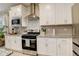 Close-up of a modern kitchen featuring stainless steel appliances, granite countertops, and stylish cabinetry at 9279 Merino Ct # D, Littleton, CO 80125