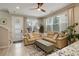 Inviting living room featuring a comfortable sectional sofa, lots of light, and stylish decor at 9279 Merino Ct # D, Littleton, CO 80125