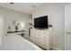 Main bedroom with a large dresser and ensuite door with bright decor at 9279 Merino Ct # D, Littleton, CO 80125