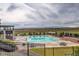 Community pool with scenic views surrounded by lounge seating and well maintained landscaping at 9279 Merino Ct # D, Littleton, CO 80125