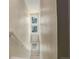 Bright stairwell with neutral paint, transom windows, and decorative art at 9279 Merino Ct # D, Littleton, CO 80125