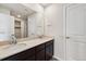 Bathroom with dual sinks set in granite countertop and dark wood cabinets, with a walk-in shower at 42754 Calusa Pines Rd, Elizabeth, CO 80107