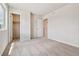 Bright bedroom with carpet, white walls, and two open closet doors at 42754 Calusa Pines Rd, Elizabeth, CO 80107
