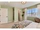 Comfortable bedroom featuring a floral comforter, a window, and sage green walls at 42754 Calusa Pines Rd, Elizabeth, CO 80107