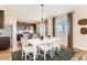 Bright dining area features a white table and chairs, pendant lighting and convenient access to the kitchen at 42754 Calusa Pines Rd, Elizabeth, CO 80107