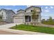 Charming two-story home featuring a covered porch, well-kept lawn, and an attached two-car garage at 42754 Calusa Pines Rd, Elizabeth, CO 80107
