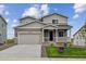 Charming two-story home featuring a covered porch, well-kept lawn, and an attached two-car garage at 42754 Calusa Pines Rd, Elizabeth, CO 80107
