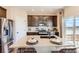Bright kitchen featuring stainless appliances, kitchen island with seating, and plenty of cabinet space at 42754 Calusa Pines Rd, Elizabeth, CO 80107