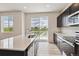Bright kitchen with stainless steel appliances, an island sink, modern cabinets, and exterior views at 42754 Calusa Pines Rd, Elizabeth, CO 80107