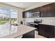 Bright kitchen featuring an island with sink, stainless appliances, modern finishes, and ample counter space at 42754 Calusa Pines Rd, Elizabeth, CO 80107