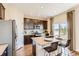 Well-lit kitchen featuring a large island with seating, stainless steel appliances, and sleek dark cabinetry at 42754 Calusa Pines Rd, Elizabeth, CO 80107